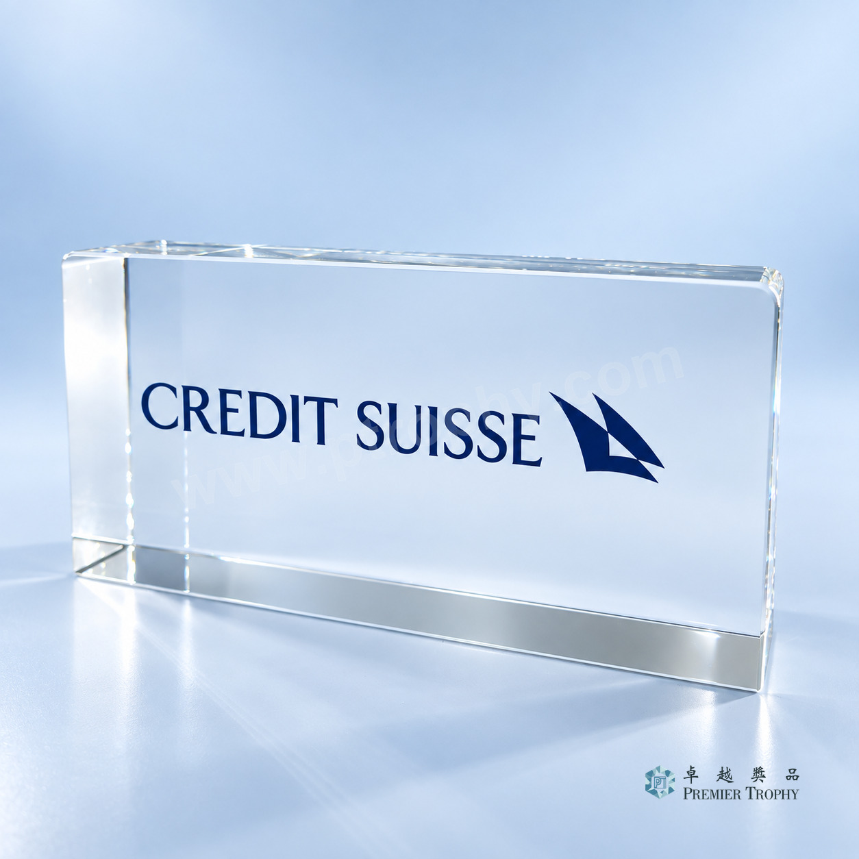 Wide optical crystal block engraved with an investment bank wordmark for a closing gift