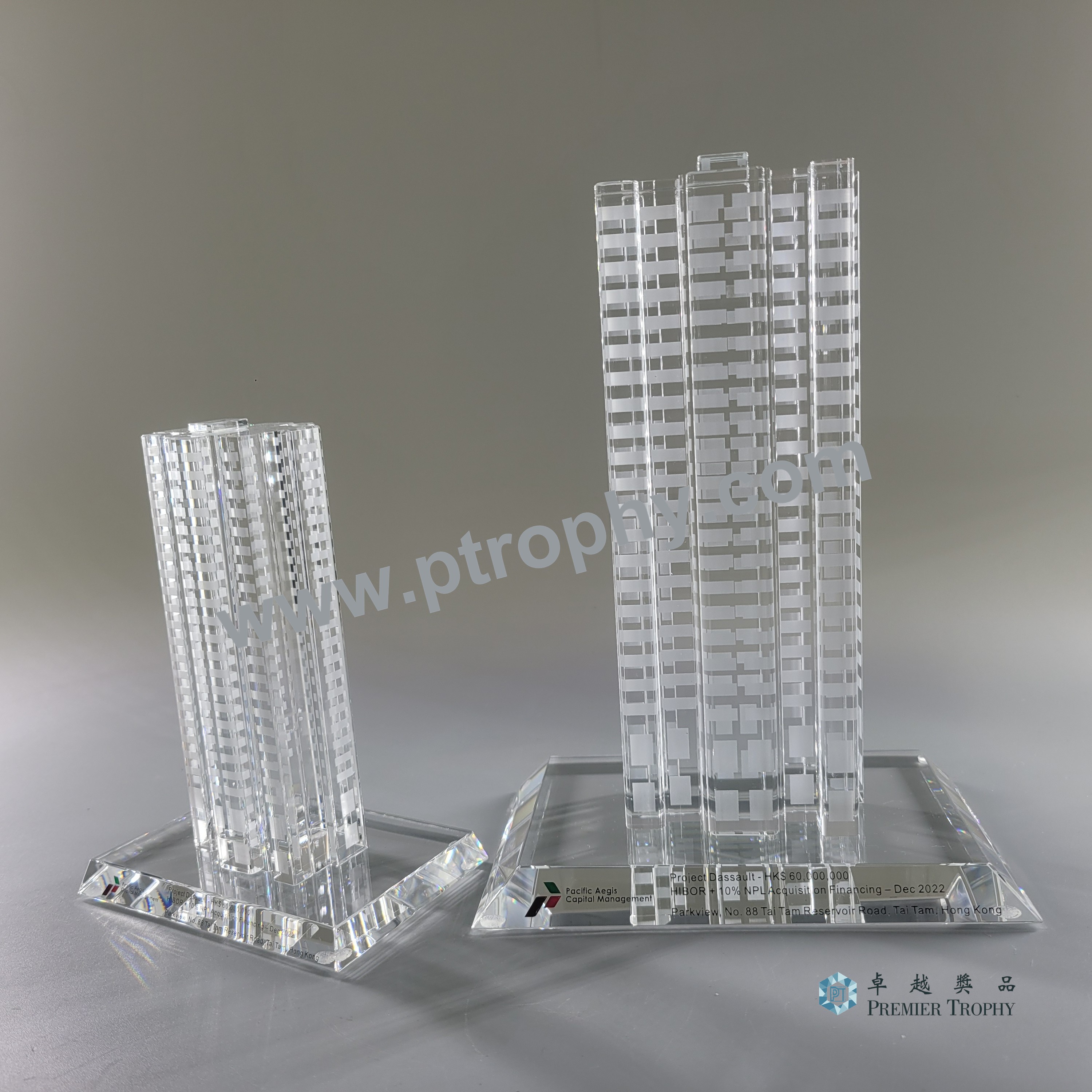 Pair of optical crystal tower models cut to the architect drawings of a completed development